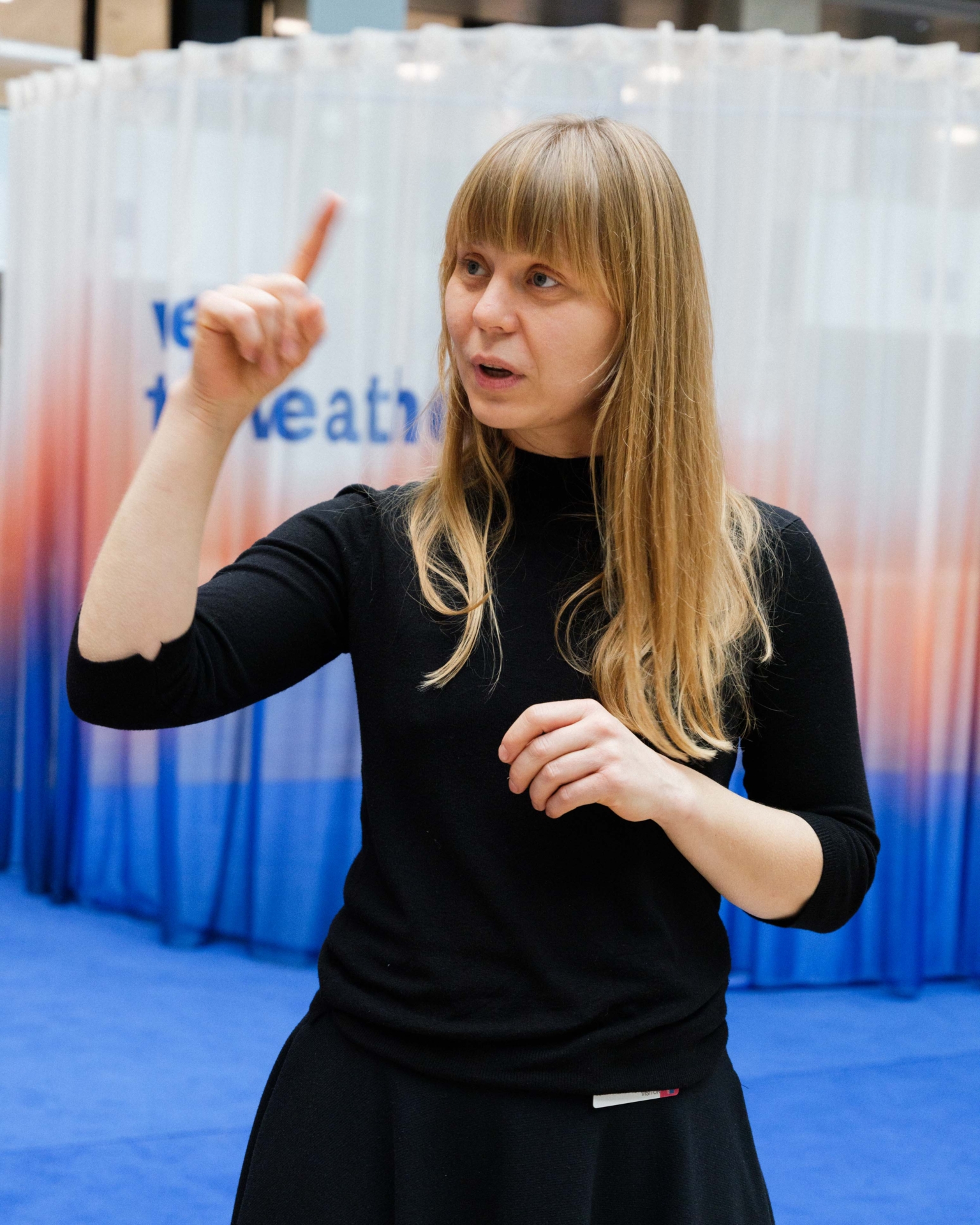 artist alicja patanowska posing in front of her artistic piece