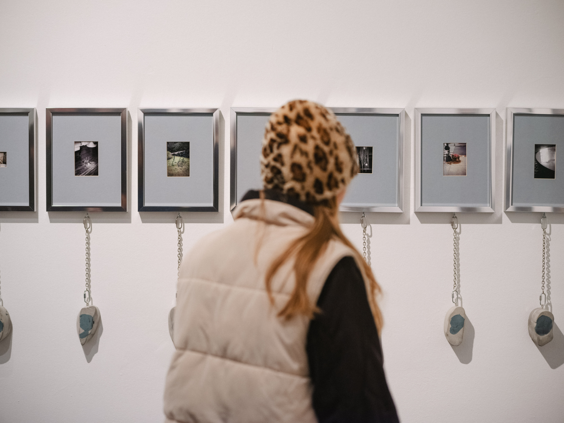 A person watching exhibited photos and items