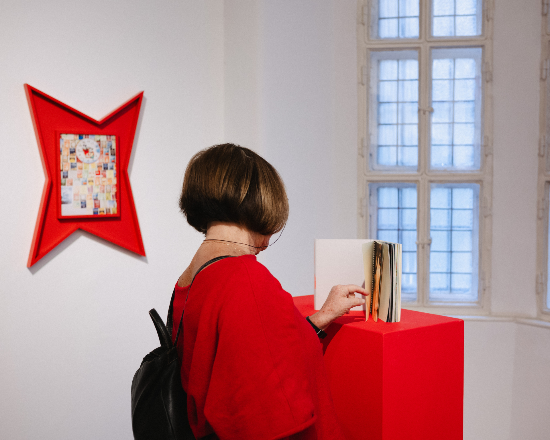A person watching exhubited photos and items