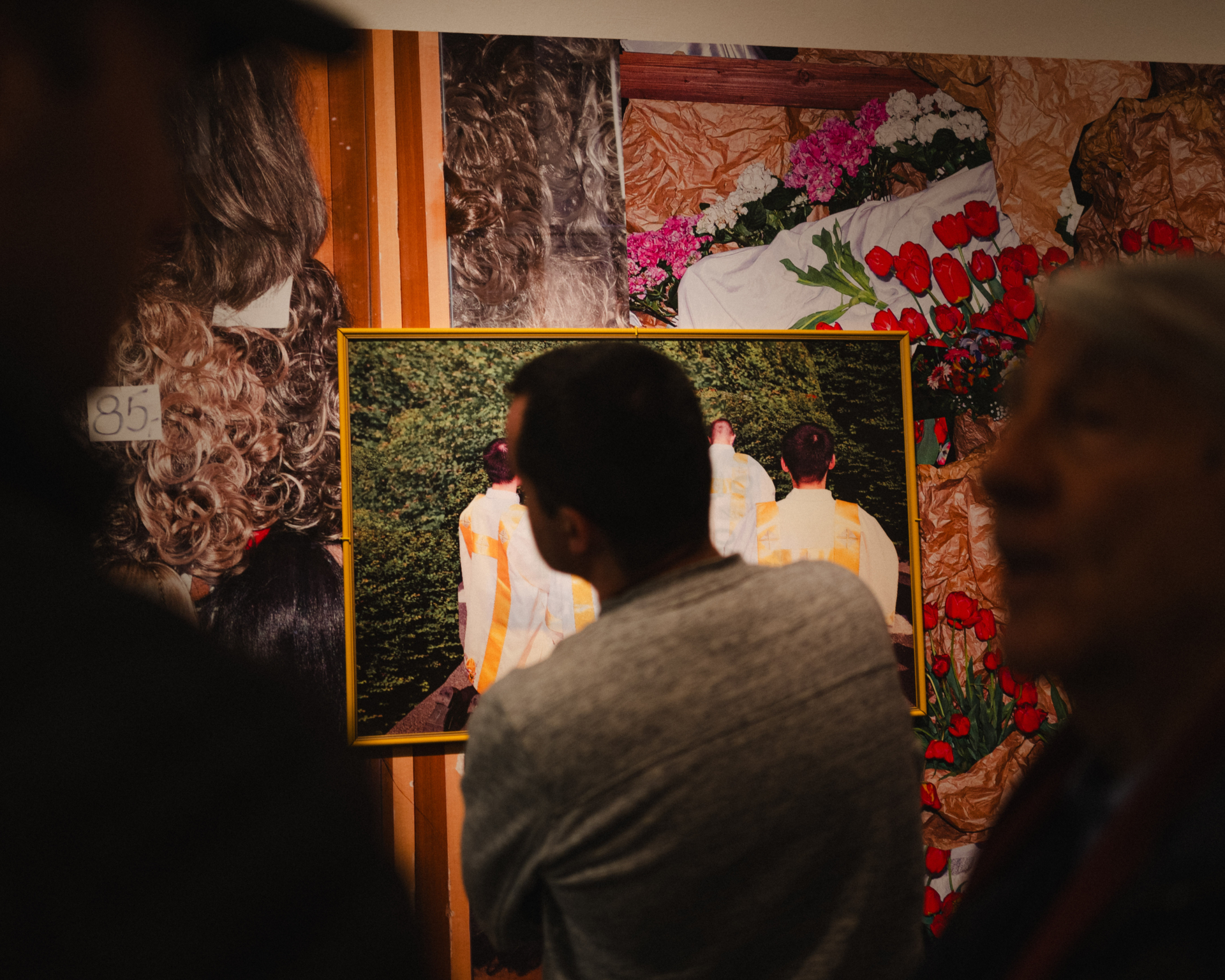 A person watching exhibited photos and items